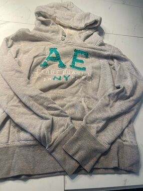 American Eagle Outfitters Zip-Up Sweater - Light Gray with Teal Appliqué